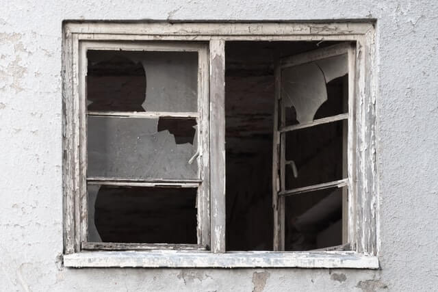 The image is of an open window with multiple broken window panes and peeling paint.

When to replace windows?" How about when they are completely falling apart.